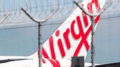 Virgin Australia jet behind razor wire (Getty)