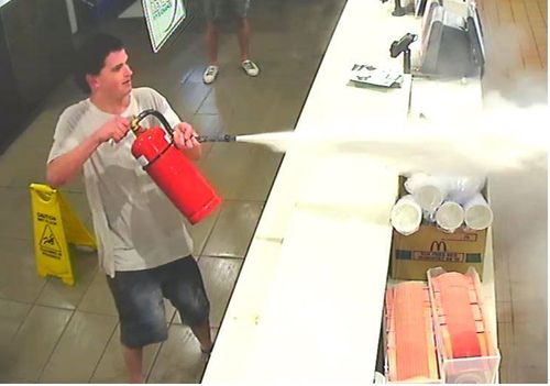 The man fired the extinguisher in the direction of staff members in the kitchen area.
