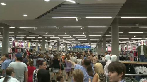 Hundreds of eager shoppers  gather outside Kmart store in Coffs Habour this morning. (9NEWS)