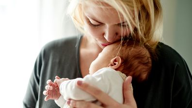 Mum holding new born baby