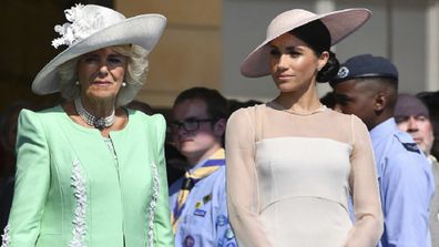 Meghan stands with Camilla during a garden party at Buckingham Palace in London, Tuesday May 22, 2018.