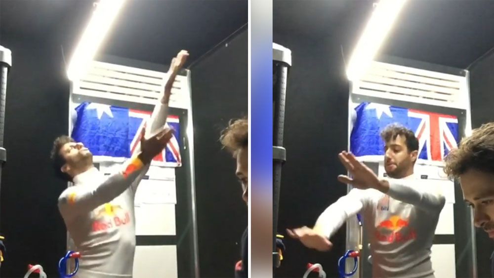 Australian Red Bull driver Daniel Ricciardo busts a move before Malaysian Grand Prix