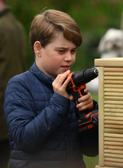 Prince George of Wales helps out with some woodwork as he joins his parents taking part in the Big Help Out, during a visit to the 3rd Upton Scouts Hut in Slough on May 8, 2023