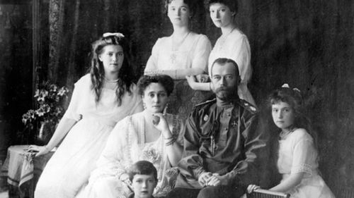 Photograph of the Romanov Family in 1914 (left to right) Marie, Queen Alexandra, Czar Nicholas II, Anastasia, Alexei (front), and standing (left to right), Olga and Tatiana (Ann Ronan Picture Library).
