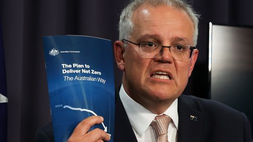 Prime Minister Scott Morrison hold the plan he claims will lead Australia to net zero by 2050.