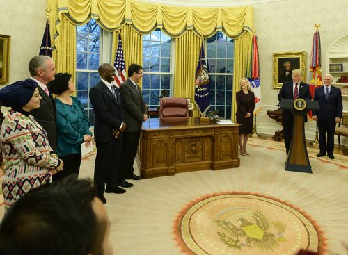 President Trump hosts a naturalisation ceremony in the Oval Office in Washington yesterday.