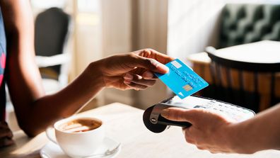 Woman buying coffee at cafe