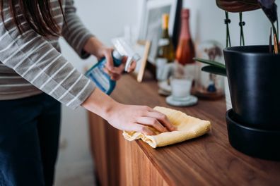 Woman doing housework cleaning surfaces