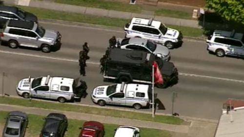 Tactical police with a Bearcat armoured vehicle. (9NEWS)
