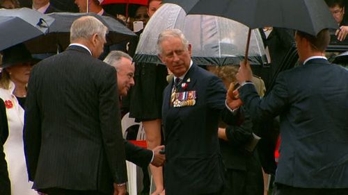 Prince Charles braves the rain in Canberra.