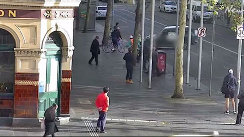 The car narrowly missed pedestrians who fled for their lives. (Herald Sun)