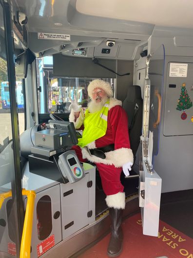 Bus driver in Santa costume Christmas bus