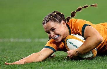 Desiree Miller of the Wallaroos scores a try.
