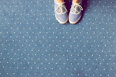 woman wearing blue shoes on carpet 