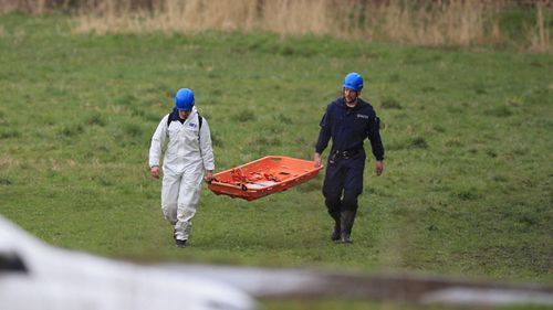 Police at the scene in a field near George Street in Heywood, Greater Manchester, after the body of a newborn baby was found. (AAP)