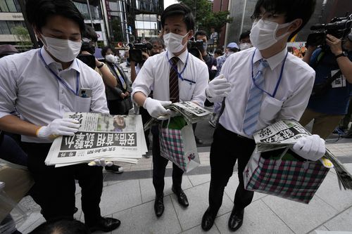 Employees prepare to distribute extra editions of the Yomiuri Shimbun newspaper reporting on Japan's former Prime Minister Shinzo Abe was shot, Friday, July 8, 2022, in Tokyo. 