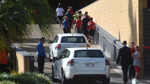 Hearses arrive at a memorial service for eight children at the Cairns Convention Centre. (AAP)