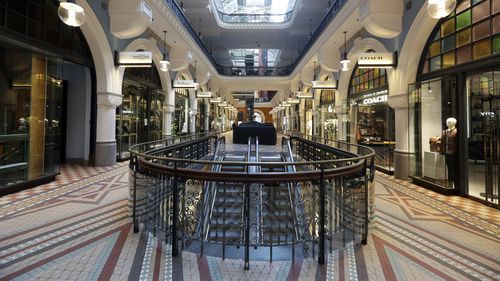 Shops are closed and shoppers absent at a mall in Sydney. 