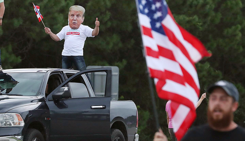 Protesters, most chanting Blue Lives Matter, yell and wave flags as the motorcade of Democratic Presidential nominee Joe Biden arrives at the Osceola Heritage Park in Kissimmee, Florida, on Tuesday, September 15, 2020. 