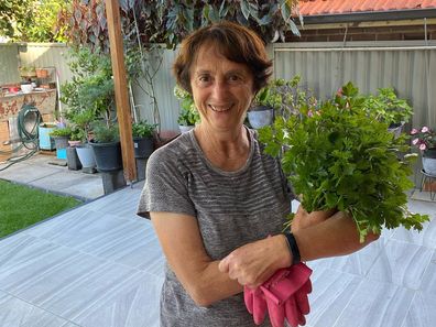 Nonna Fina shows off fresh herbs from her garden.