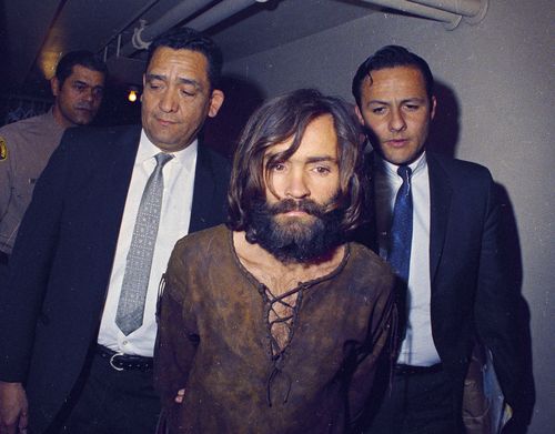 Charles Manson is escorted to his arraignment on conspiracy-murder charges in conneciton with the Sharon Tate murder case, 1969, Los Angeles, Calif. (AP Photo)