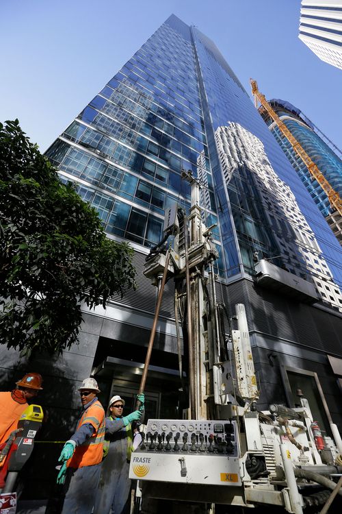 Earth engineers install data collection devices and obtain soil samples outside the Millennium Tower in San Francisco
