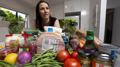 Woman in kitchen with groceries