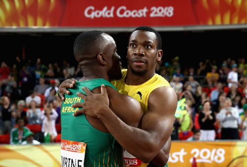 Simbine and Blake embrace after the shock upset. (Getty)