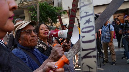 Farmers from Atenco with machetes gather outside Venezuela's embassy to protest against the US capture of President Nicolas Maduro in Mexico City.