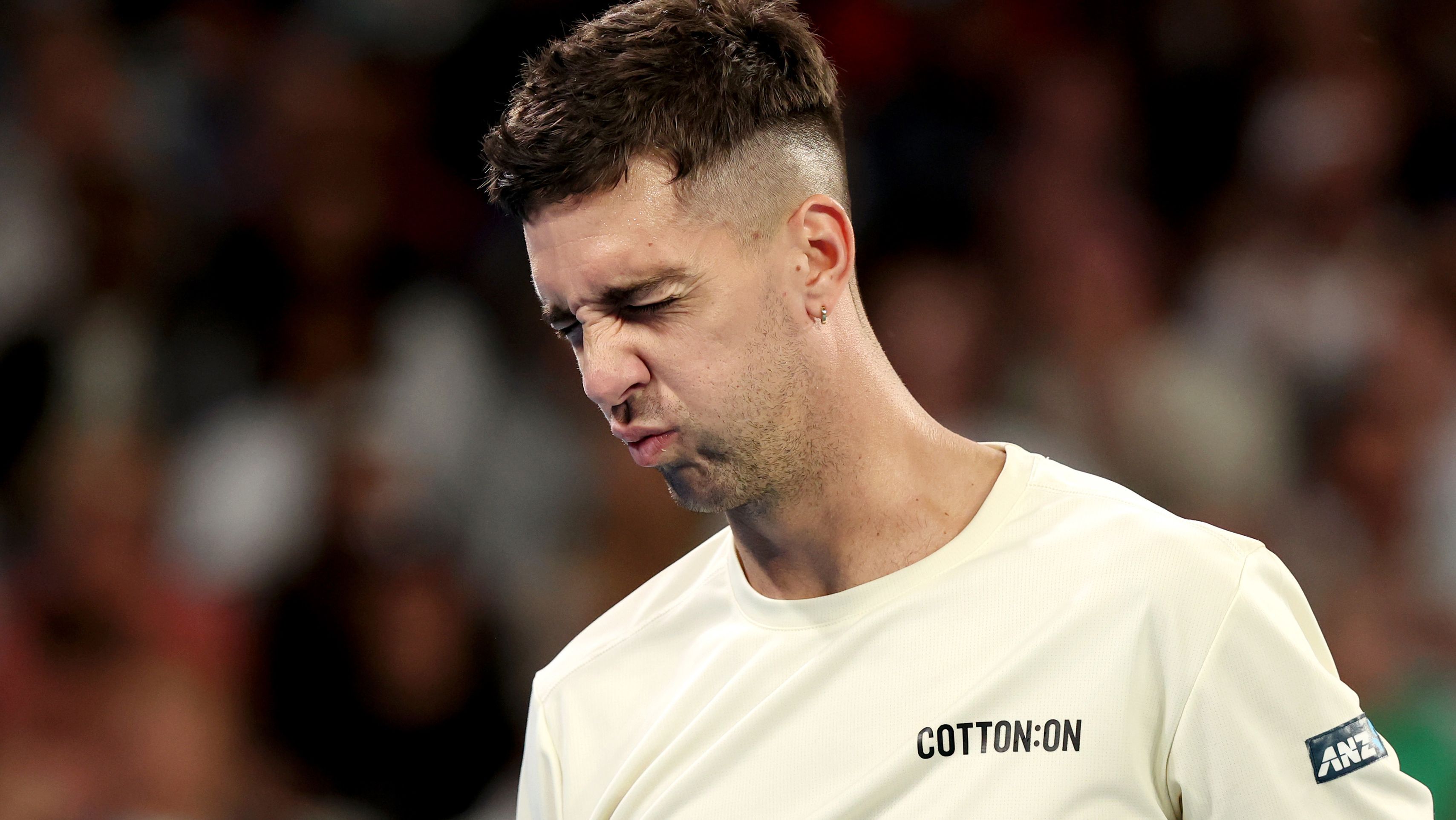 Thanasi Kokkinakis of Australia reacts in their round two singles match against Grigor Dimitrov.