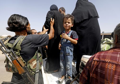 Displaced Syrians who fled from the Islamic State group's stronghold of Raqqa arrive in the village of Hawi al-Hawa, less than two kilometres west outside the city, on August 8, 2017. (AFP)