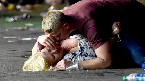 A concertgoer is comforted by a friend after being hit.