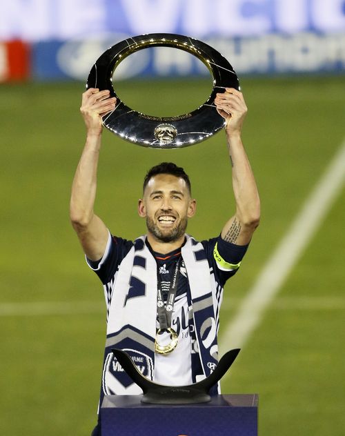 Carl Valeri of the Victory holds the trophy. (AAP)