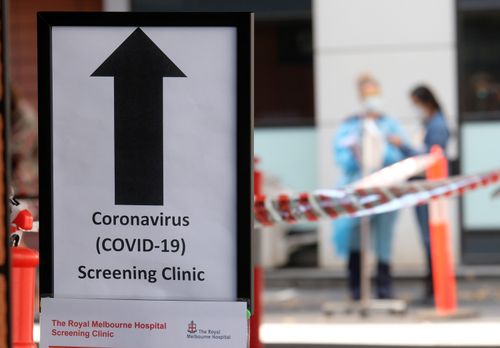 MELBOURNE, AUSTRALIA - MARCH 11: A sign directing people to the COVID-19 screening area is posted outside the Royal Melbourne Hospital on March 11, 2020 in Melbourne, Australia. Seven coronavirus screening clinics are now open in Victoria to help avoid the further spread of COVID-19. 18 people in Victoria have now been diagnosed with the virus, with the Australian total of confirmed cases now at 100.(Photo by Luis Ascui/Getty Images)