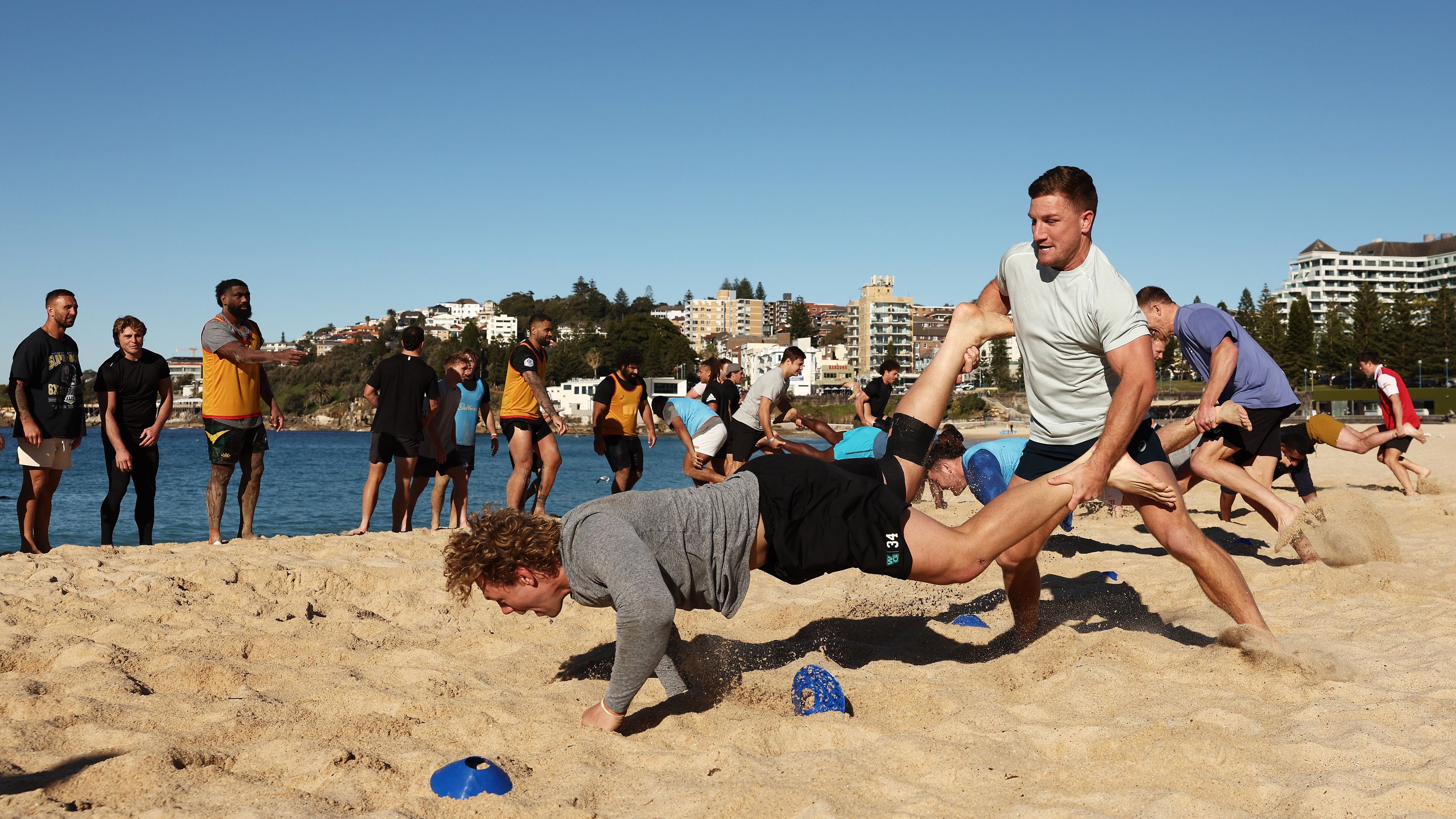 James Tuttle and Ned Hanigan take part in a drill during Wallabies training at Coogee Beach.