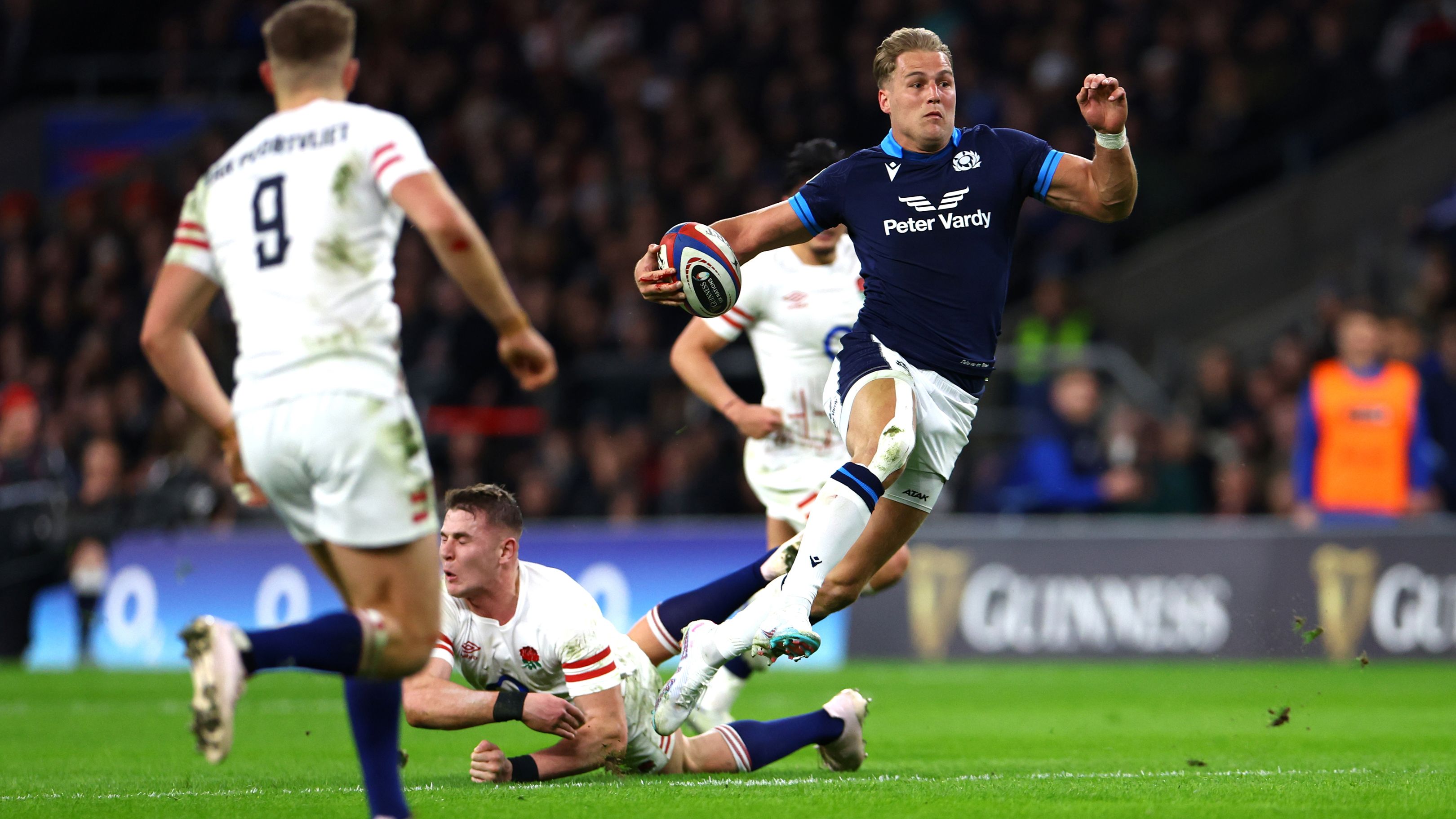 Duhan van der Merwe of Scotland breaks with the ball before touching down.