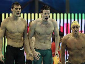 Matthew Targett, James Magnussen and Matthew Abood of Australia cheer on teammate Eamon Sullivan in the men's 4x100m freestyle relay. (Getty)
