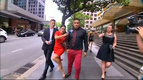 The moment reporter Leonie Ryan says she was stomped on by John Hopoate. (9NEWS)