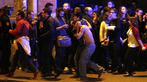 Wounded people are evacuated outside the scene of a hostage situation at the Bataclan theatre in Paris, France, 14 November 2015. Dozens of people have been killed in a series of attacks in the French capital Paris