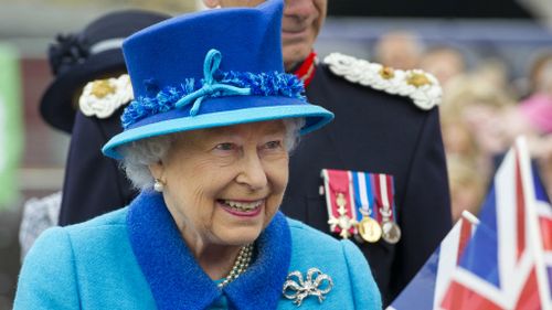 Queen Elizabeth II greets well-wishers as she opens Newton Grange railway station.