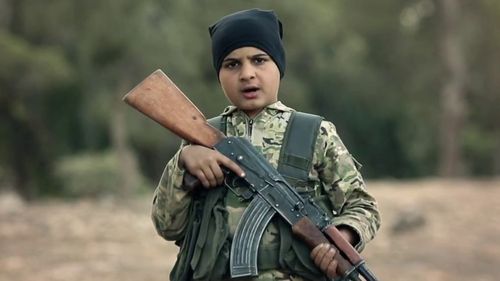 A young boy holds a weapon in an ISIS video promoting its Cubs of the Caliphate program.