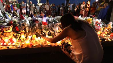 A woman and her child attend a vigil outside the French embassy