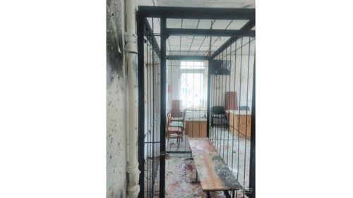 The cage in which the defendants sat during the trial. (Image: Ukrainian Police Facebook)