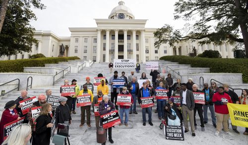 Nearly one hundred protestors gather at the state capitol building in Montgomery, Ala., on Tuesday, Jan. 23, 2024, to ask Gov. Kay Ivey to stop the planned execution of Kenneth Eugene Smith. (Mickey Welsh/The Montgomery Advertiser via AP)