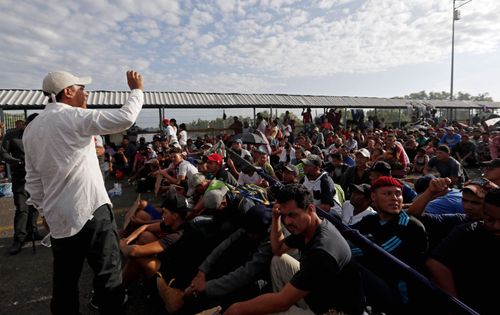 Honduran migrants wait on the bridge between Tecun Uman, Guatemala, and Mexico.