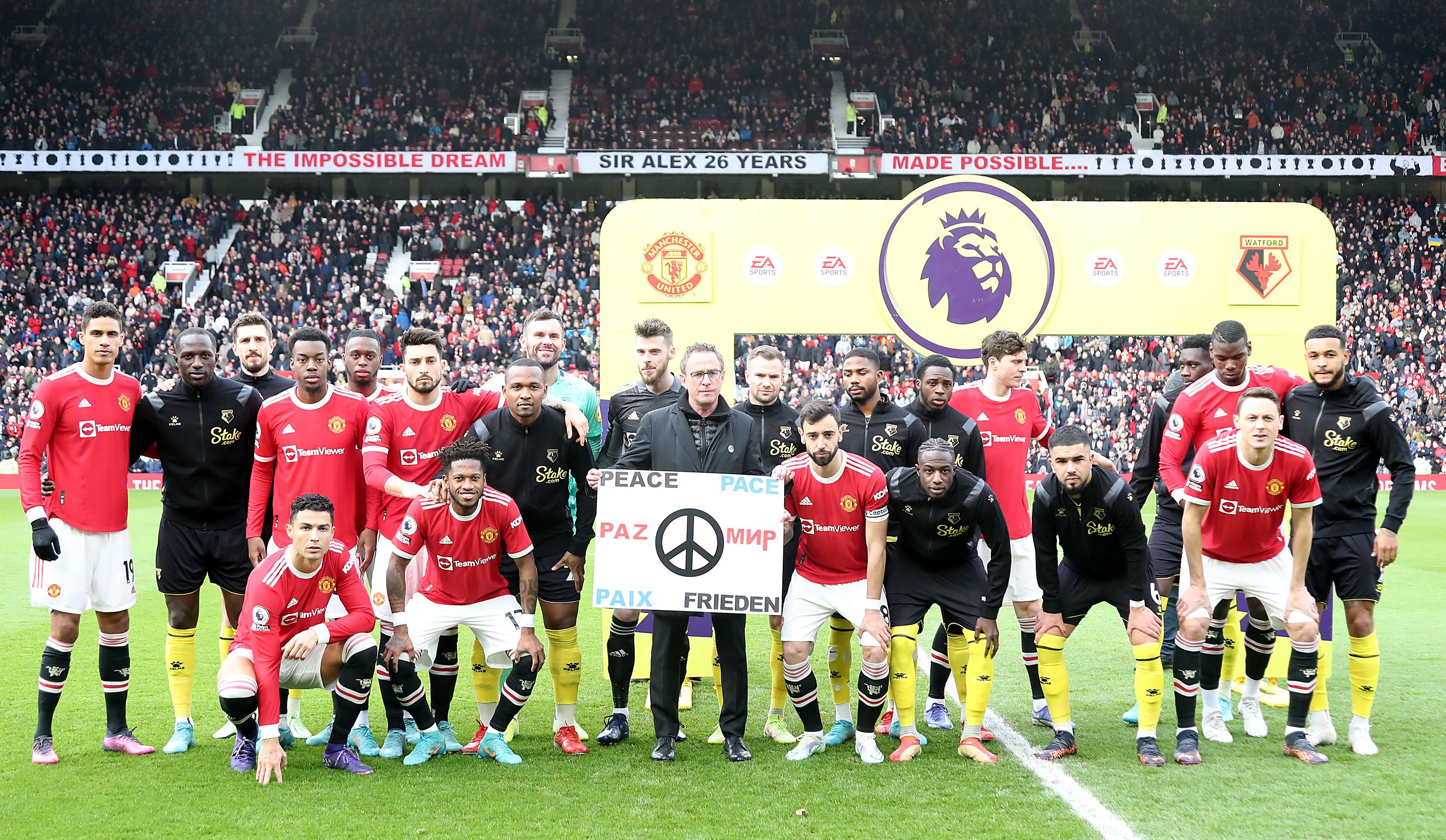 Both teams pose behind a sign reading Peace in several languages ahead of the Premier League match between Manchester United and Watford.