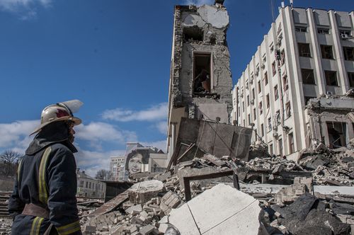 Rescuers work at the site of the National Academy of State Administration building damaged by shelling in Kharkiv, Ukraine, March 18, 2022 