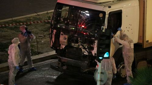 Forensics officers collect evidence from the truck used in the massacre. (AAP)