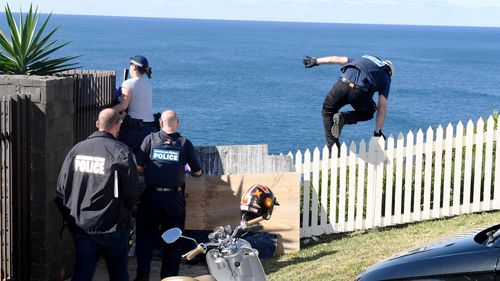 Police are seen at the home of Kings Cross club owner John Ibrahim during a police operation in Sydney. (AAP)