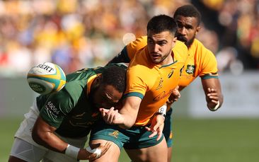 Tom Wright of the Wallabies offloads against the Springboks.